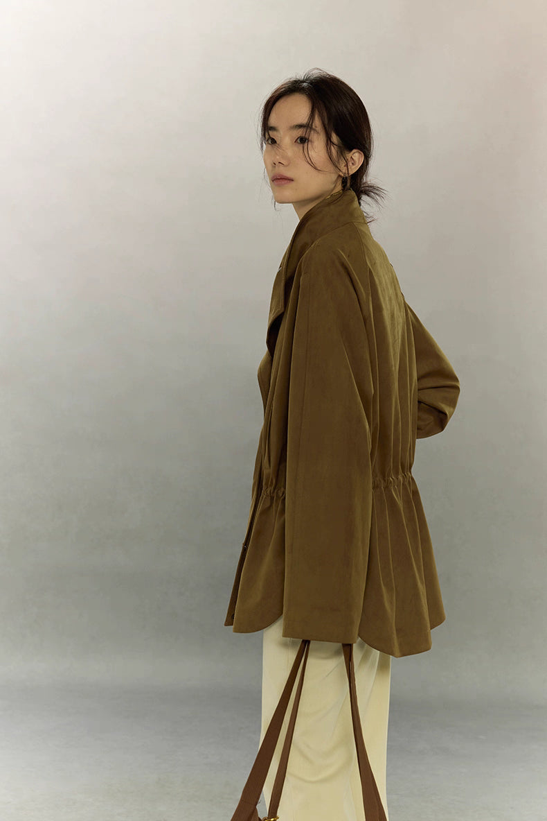 Side profile of caramel suede utility jacket showing soft drape and stand collar.