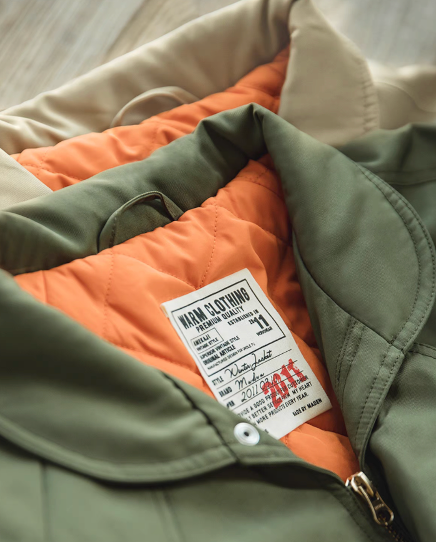 Close-up of Flight Jacket 074 orange quilted lining and label details