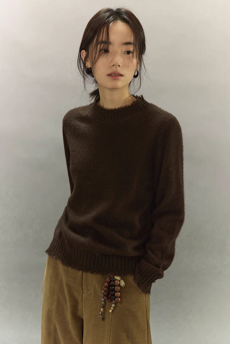 Model wearing dark coffee brown yak wool sweater with clean semi-high neckline.