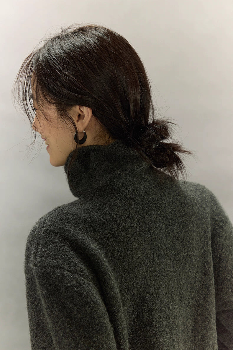 Back view focusing on the high-neck collar and soft brushed wool texture of the dark charcoal cardigan.