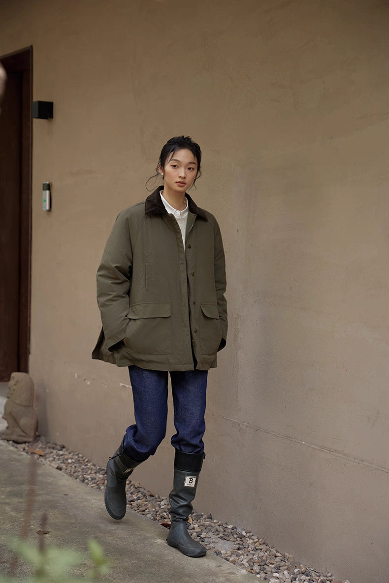 Full-body shot of model in army green heritage down jacket and jeans outdoors.