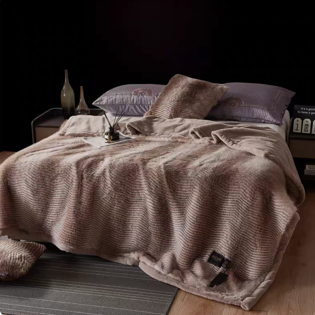 Patterned Coffee long-pile faux fur luxe throw blanket layered across bed with warm brown striped texture