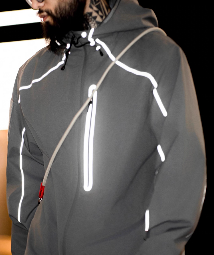 Grey LIGHTSABER reflective jacket glowing under city night lighting