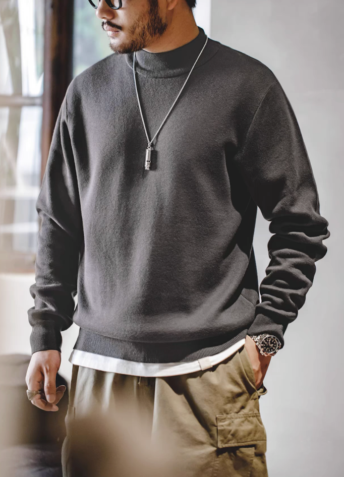 Men’s charcoal gray half turtleneck knit sweater — soft heavyweight pullover styled for everyday wear, shown with khaki pants and layered undershirt.