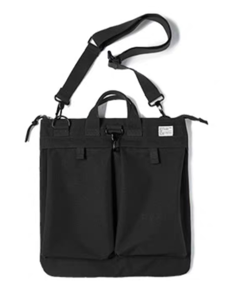 Charcoal black canvas tote bag front view with dual handles and adjustable shoulder strap on a plain background.