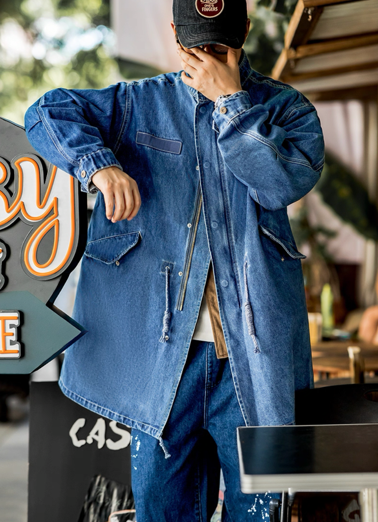 Model wearing denim fishtail parka with cap urban street style