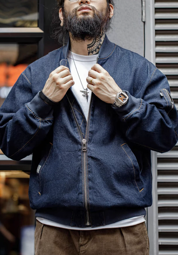 Model wearing Heritage Denim MA-1 Jacket zipped up, adjusting collar