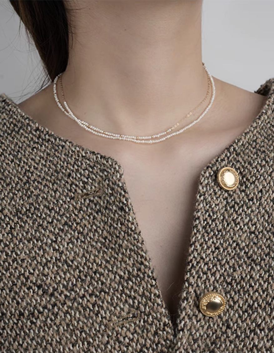 Model wearing rice pearl necklace with 14K gold-filled accents featuring both Style A and Style B layered together