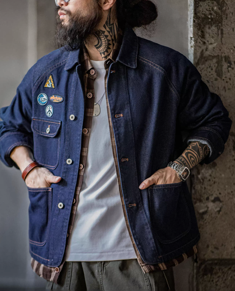 Model layering heritage denim jacket over plaid shirt