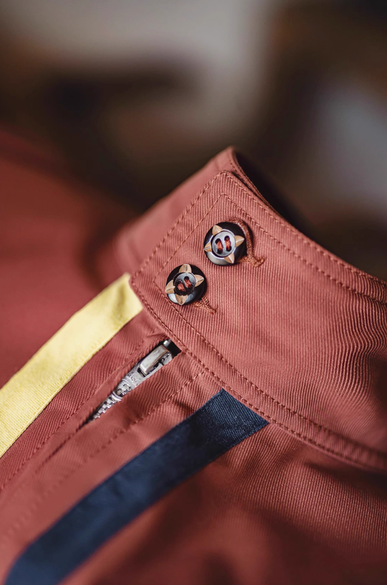 Close-up of button collar and zipper detail on retro 60s racing jacket