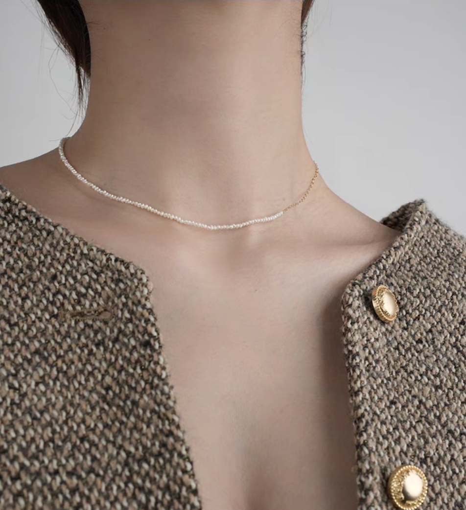 Front view of model wearing rice pearl necklace with 14K gold-filled accents in Style A showing double-layer pearl design
