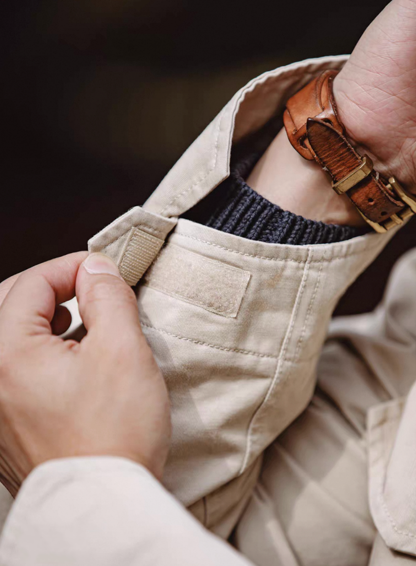 Close-up of Velcro-adjustable cuff tab showing reinforced stitching