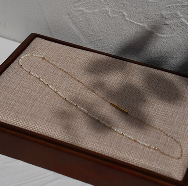 Rice pearl necklace with 14K gold-filled accents in Style B laid flat in box showing single strand pearl and gold chain