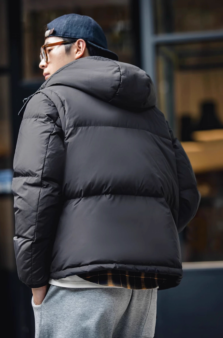 Back angle of black parka showing hood and matte texture