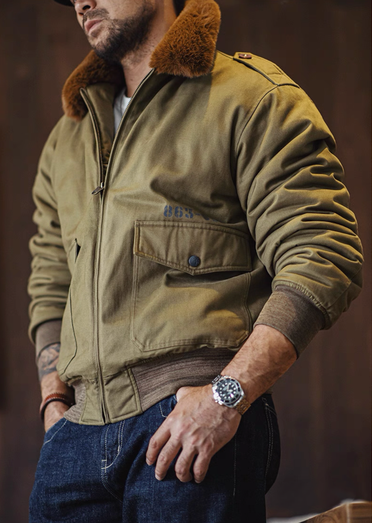 Model standing indoors wearing B-10 flight jacket with jeans, showing natural relaxed fit.