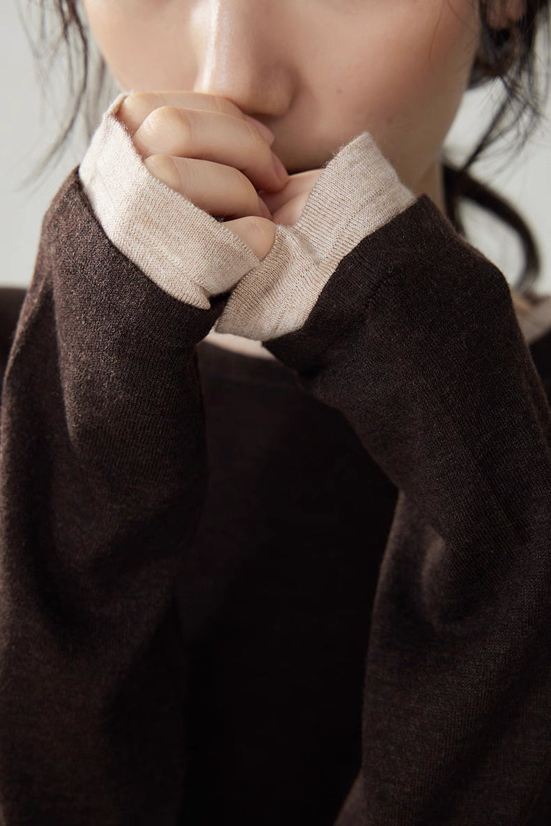 Close-up of beige cuff and neckline trim on dark brown double-layer wool cashmere top