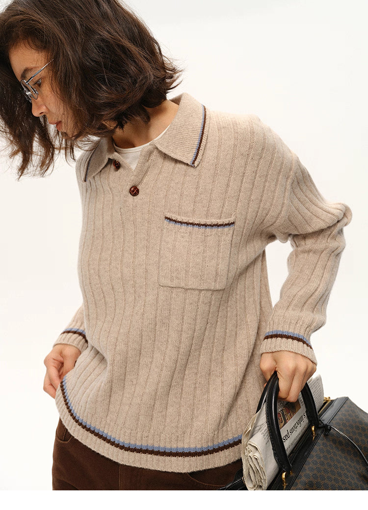 Model leaning forward in ribbed wool polo sweater showing rib texture and relaxed fit.