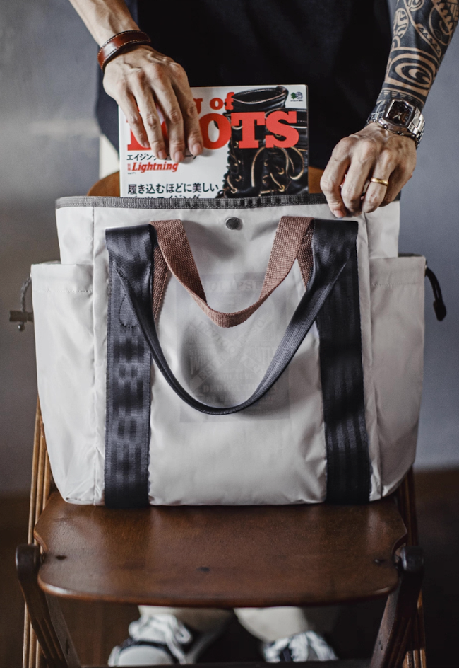 All-Weather Outdoor Tote Bag front view showing dual handles and reflective print