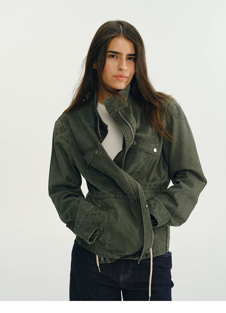 Army green field jacket with the waist drawstring pulled in to define the waist