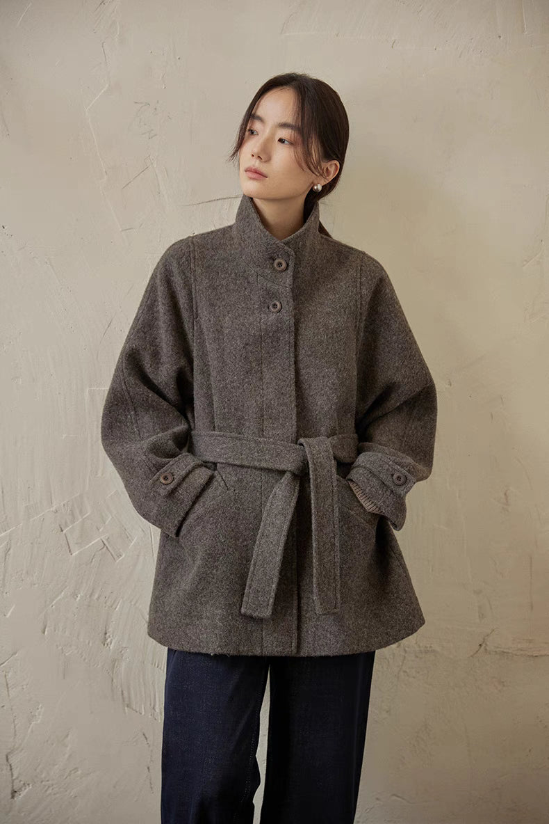 Gray wool belted jacket front portrait view highlighting stand collar and soft brushed texture