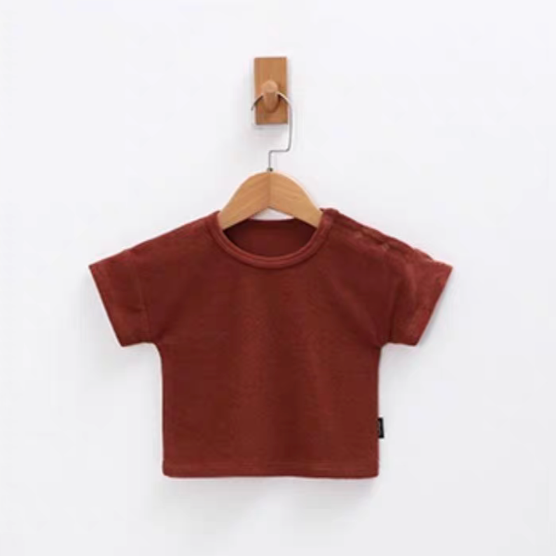 Rust red baby terry cotton short sleeve top hanging on wooden hanger front view