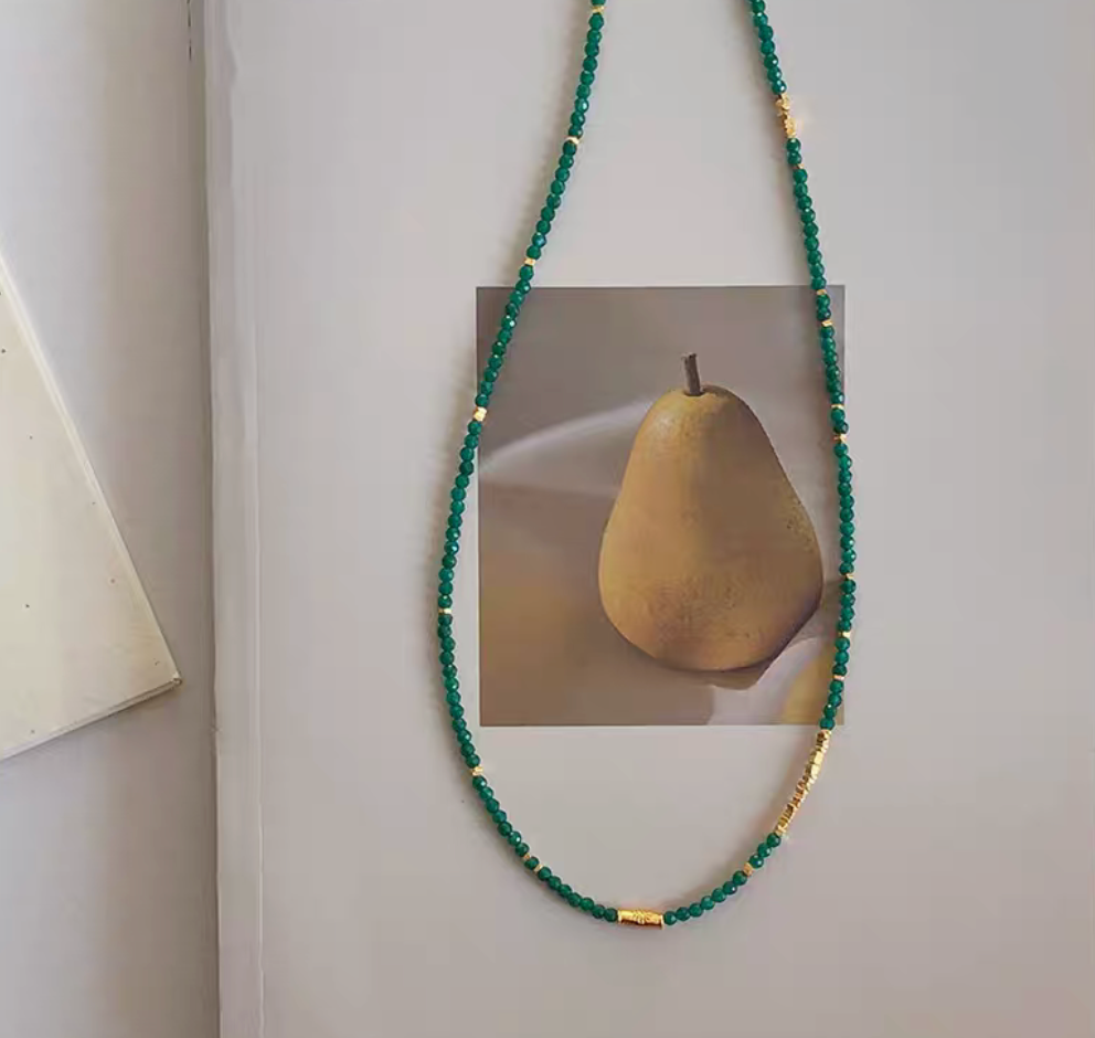 Full view of Barcelona Green Agate Choker with green agate beads and gold plated silver accents styled on wall display