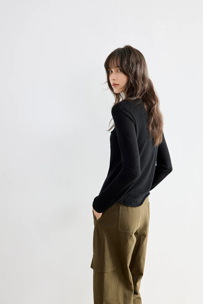Black wool cardigan, side-back view on model