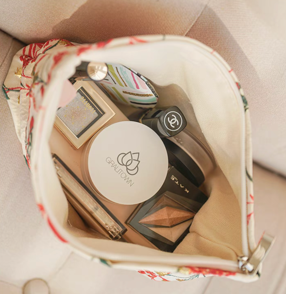 Botanical Embroidered Zip Makeup Pouch in red floral embroidery opened to reveal makeup items neatly organized inside