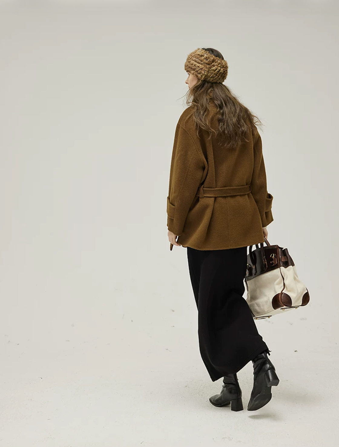 Back view of a Brown short wool coat with belt through back loops and dropped shoulders