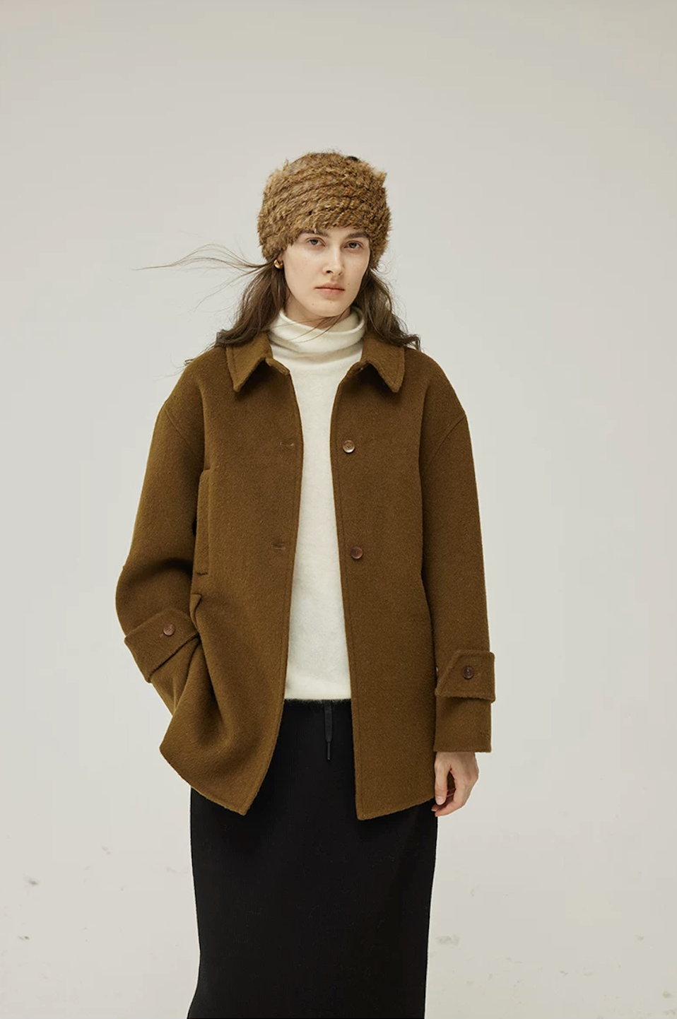 Front view of a Brown double-face wool coat with point collar, button front, and buttoned cuff tabs
