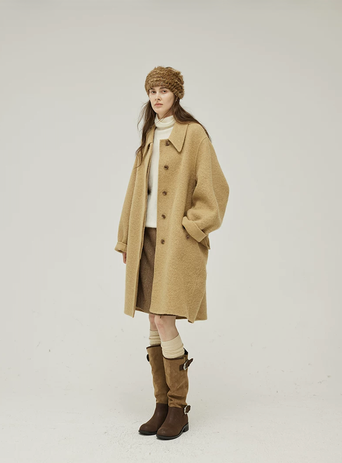Camel knee-length wool coat with big point collar, tortoiseshell-look buttons, and cuffed sleeves