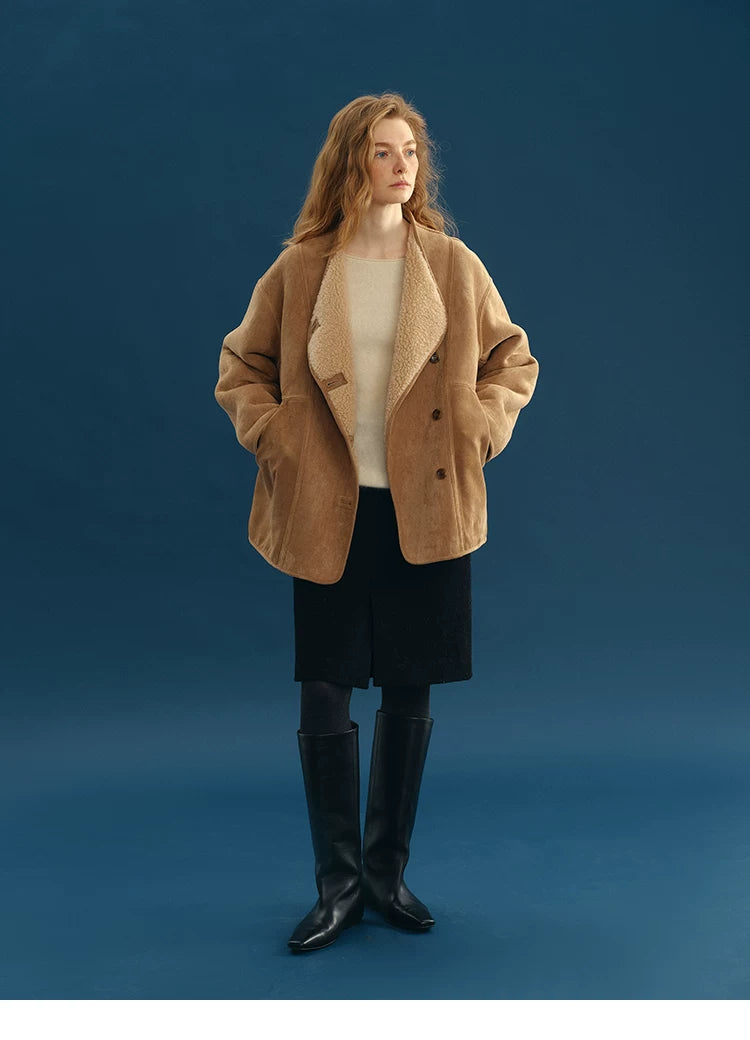 Camel reversible faux-shearling jacket worn with hands in the topstitched side pockets