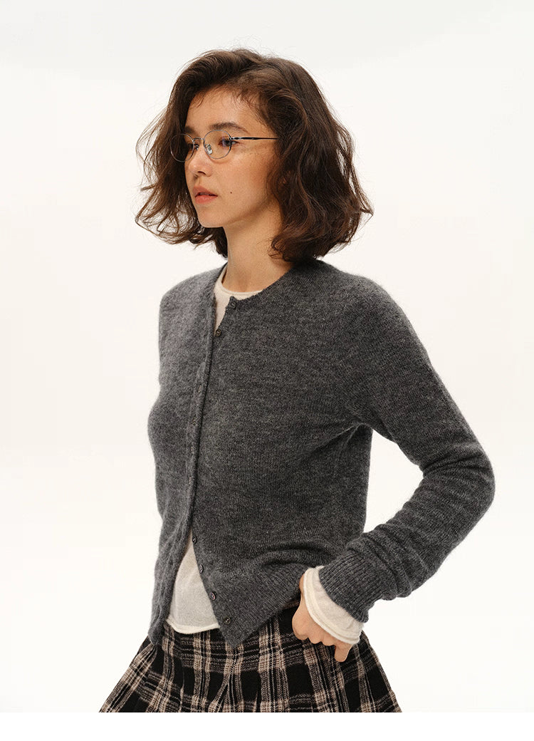 Woman in charcoal gray alpaca cardigan and plaid skirt, side profile portrait