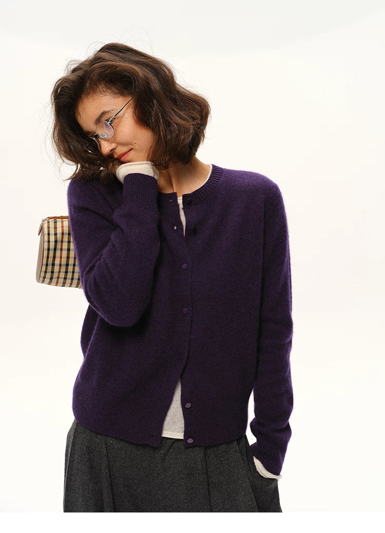 Woman in deep purple cardigan in a soft pose with button-front design