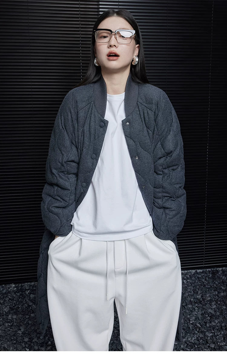 Charcoal quilted wool-blend down coat worn open, showing the ribbed stand collar and snap front