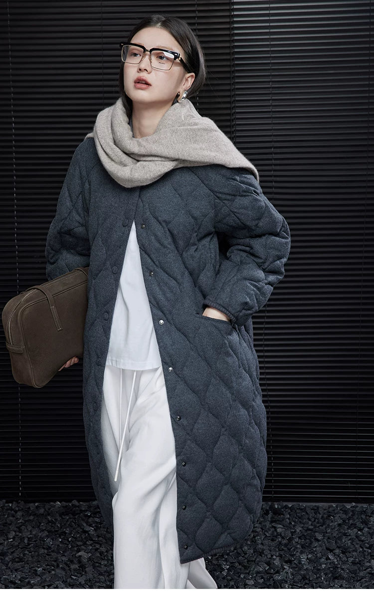 Charcoal oversized quilted down coat with snap front and hand in the side pocket