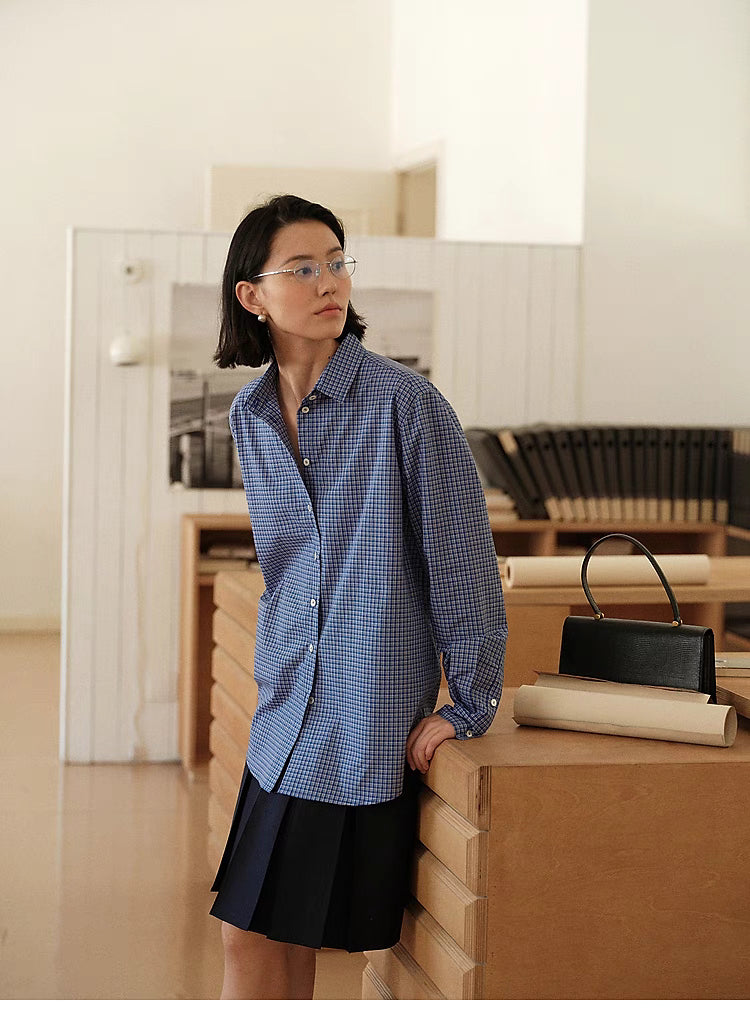 Checkered Ease Shirt blue plaid long sleeve relaxed fit front view styled with black skirt in indoor setting