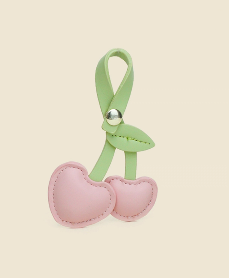 Pink cherry heart PU leather keychain front view with soft pastel hearts and green strap