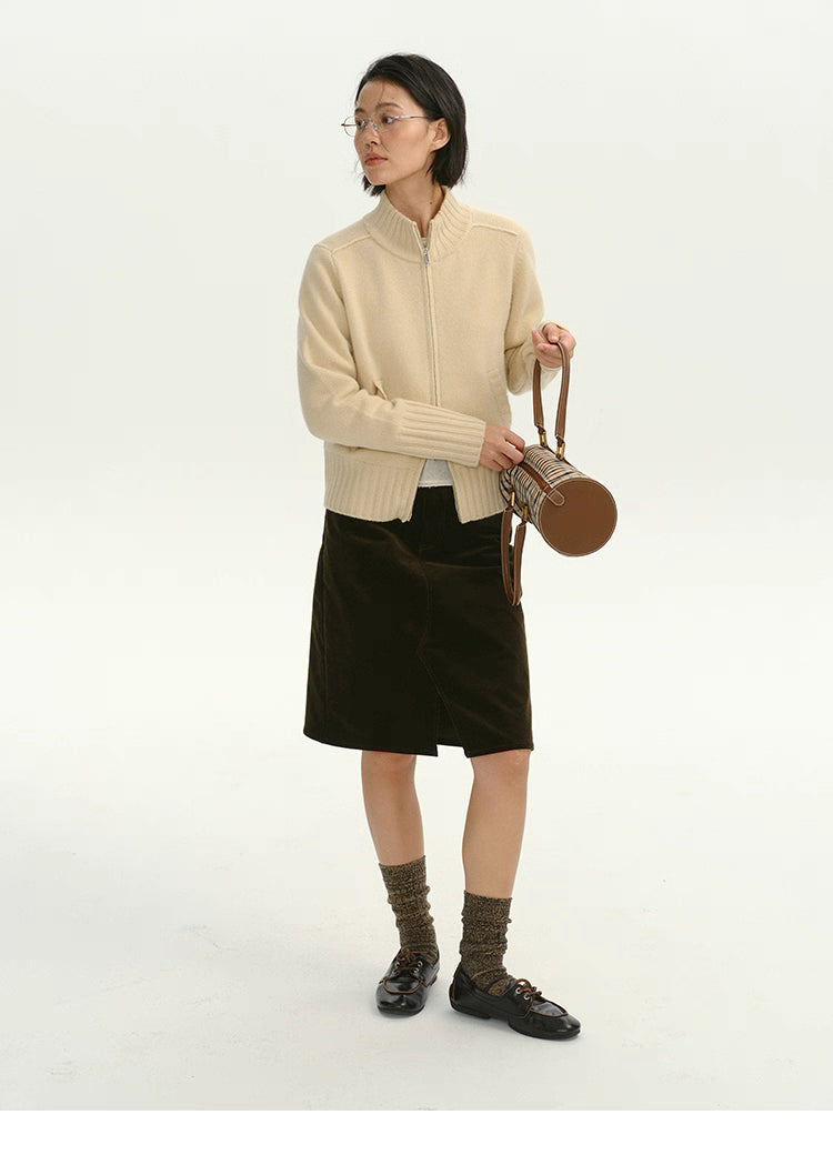 Full-body outfit featuring cream wool zip-up cardigan styled with brown skirt and handbag