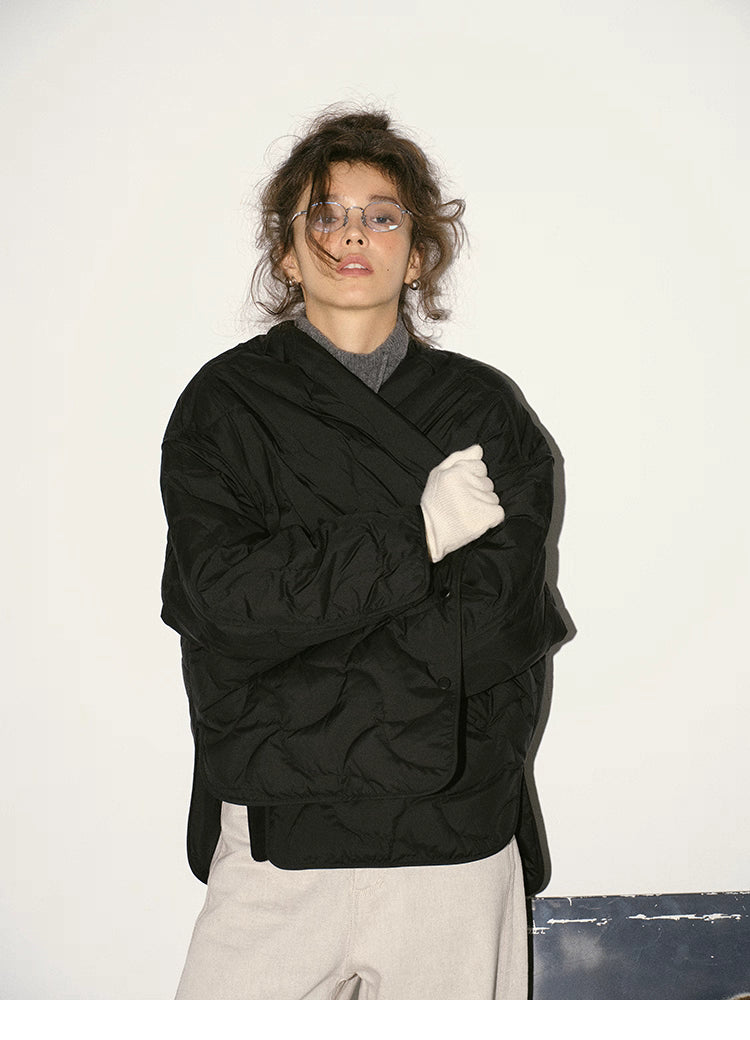 Black quilted down jacket styled cross-wrapped at front for cozy layered look.