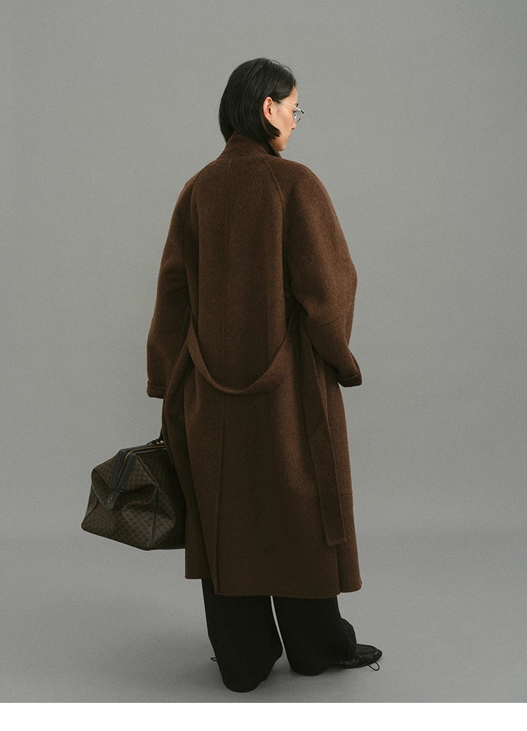 Full back view of oversized dark coffee wrap coat showing belt loop and hemline.