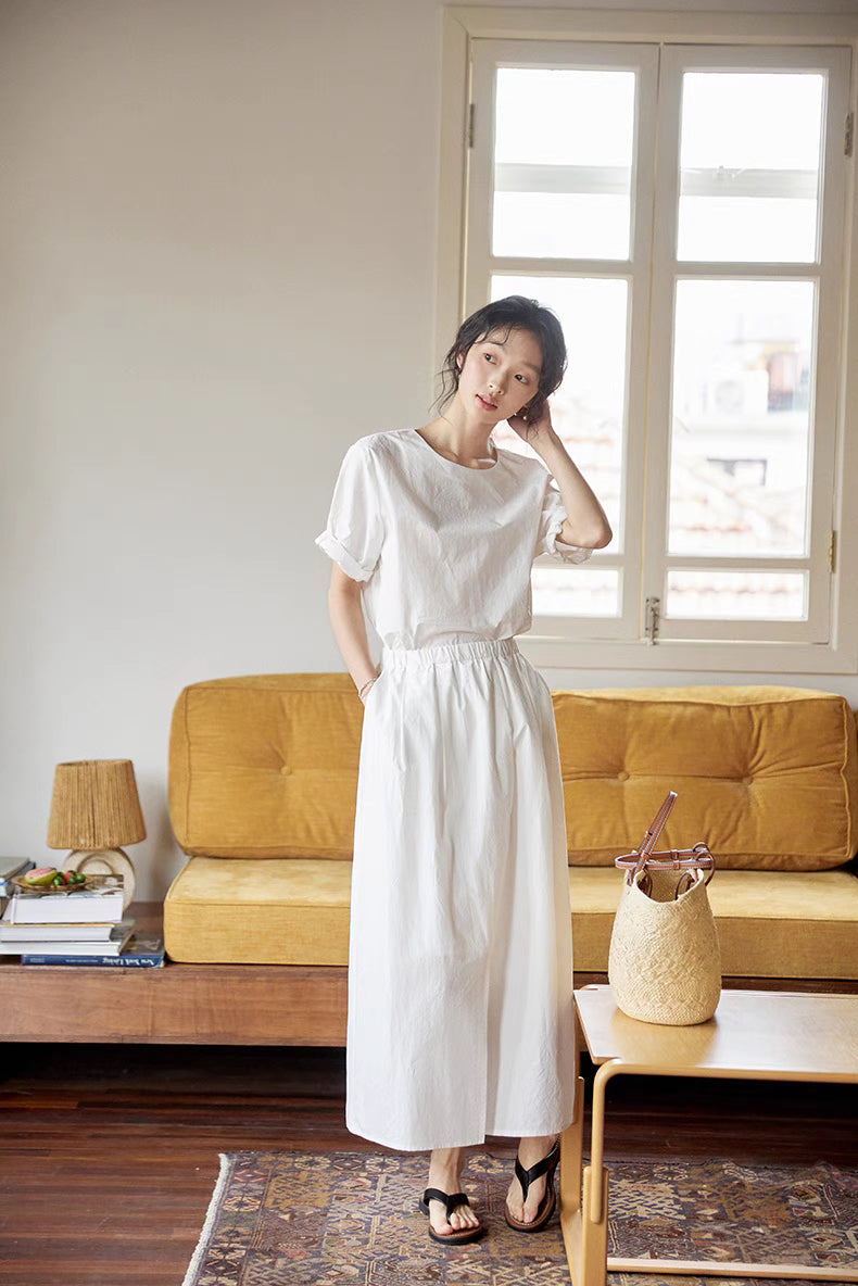 Full body indoor view of Coastal Breeze Cotton Top & Skirt Set in white showing soft lightweight cotton, relaxed fit and minimalist summer outfit styling