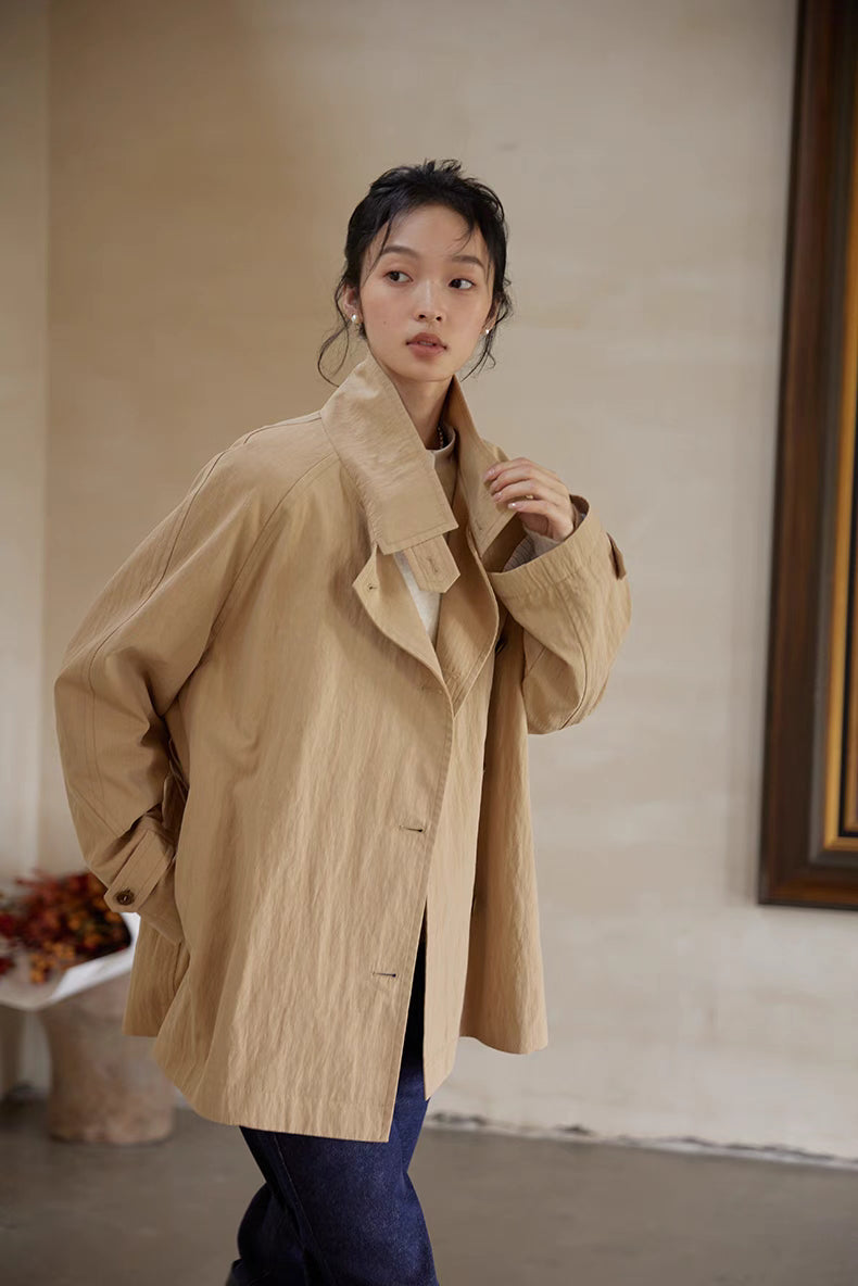 Light brown short trench coat styled casually with relaxed fit and open front look