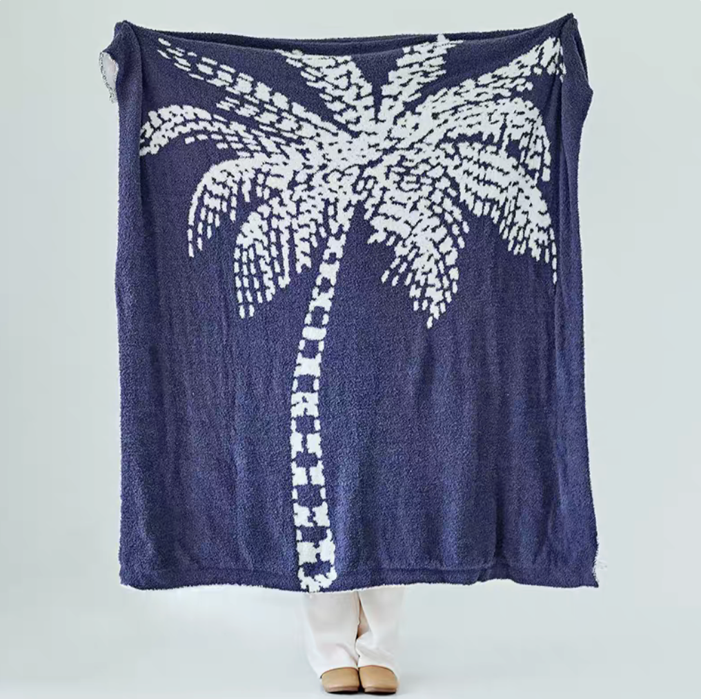 Blue coconut tree jacquard throw blanket fully displayed with contrasting white palm tree design