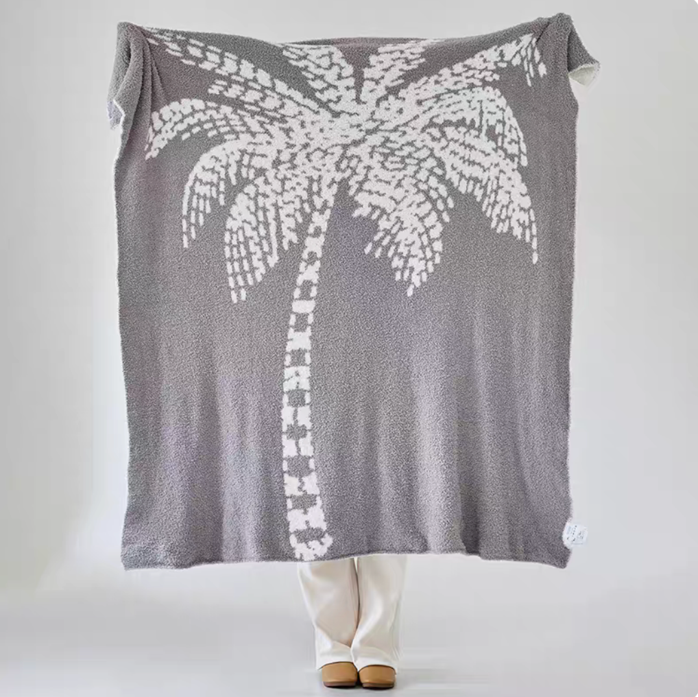 Gray coconut tree jacquard throw blanket fully displayed with large white palm tree motif