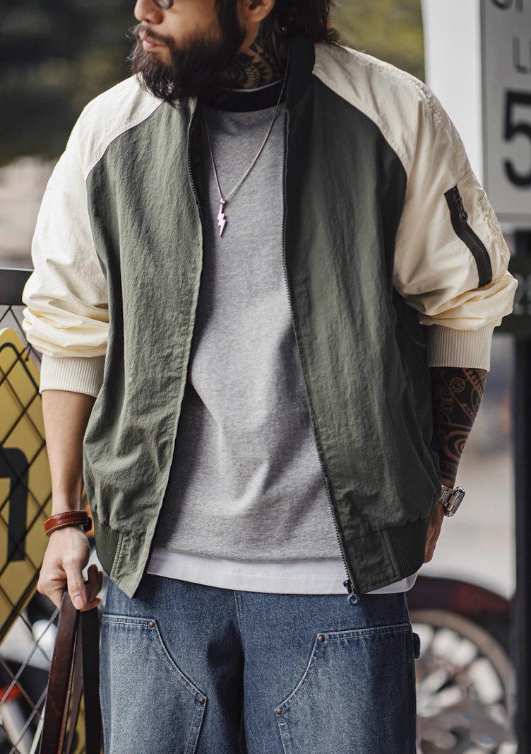 Two-tone MA-1 bomber styled with gray tee and jeans for urban outfit