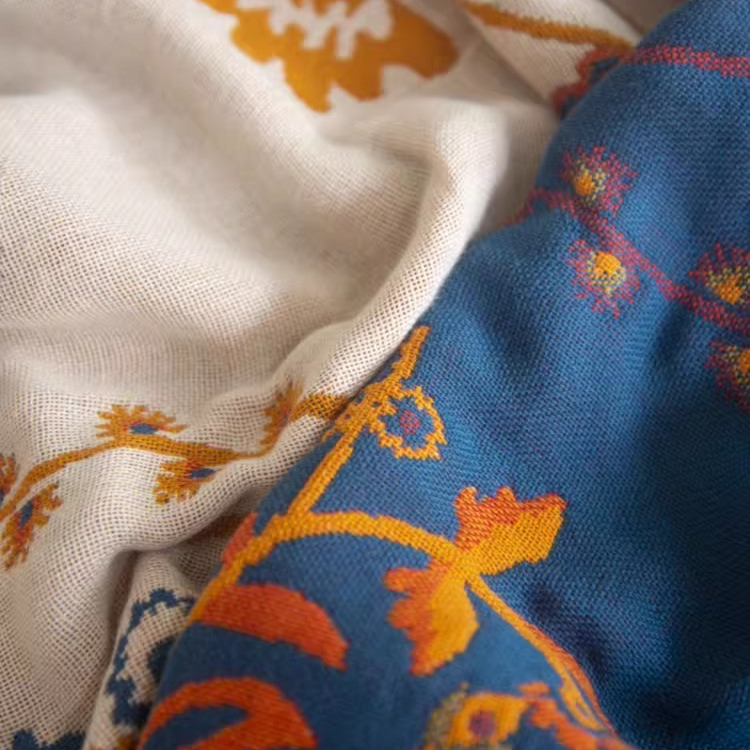 Close-up of Colorful Super Soft Long-staple Cotton Blanket Time Blossom reverse side showing blue floral cotton fabric texture