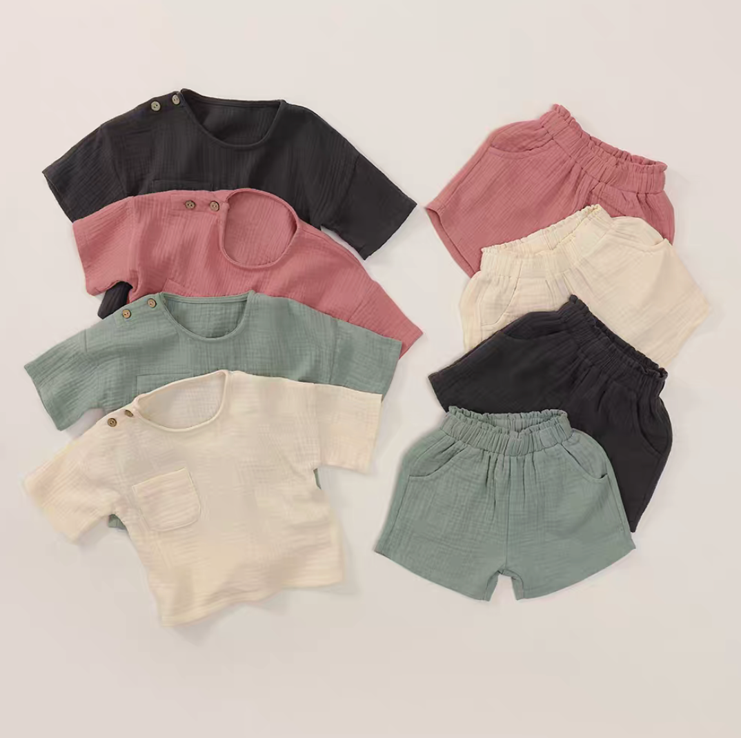Crinkle gauze cotton baby set flat lay showing multiple colors shirt and elastic shorts breathable summer outfit