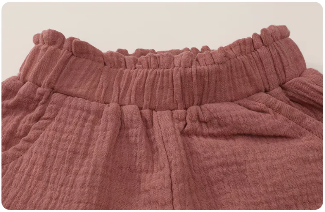 Hot pink gauze cotton baby shorts elastic waistband detail soft breathable fabric close up