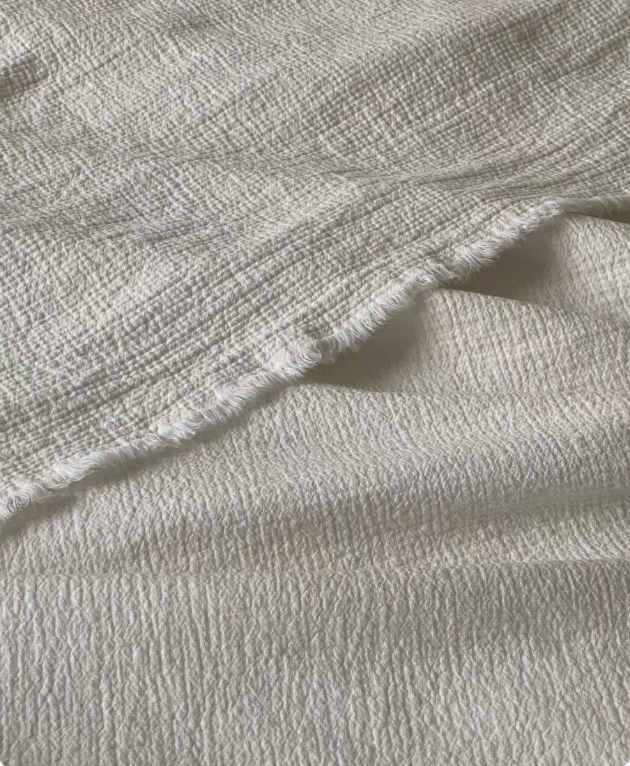 Minimalist bedroom styled with ivory white French flax linen duvet thin quilt featuring lightweight breathable linen bedding